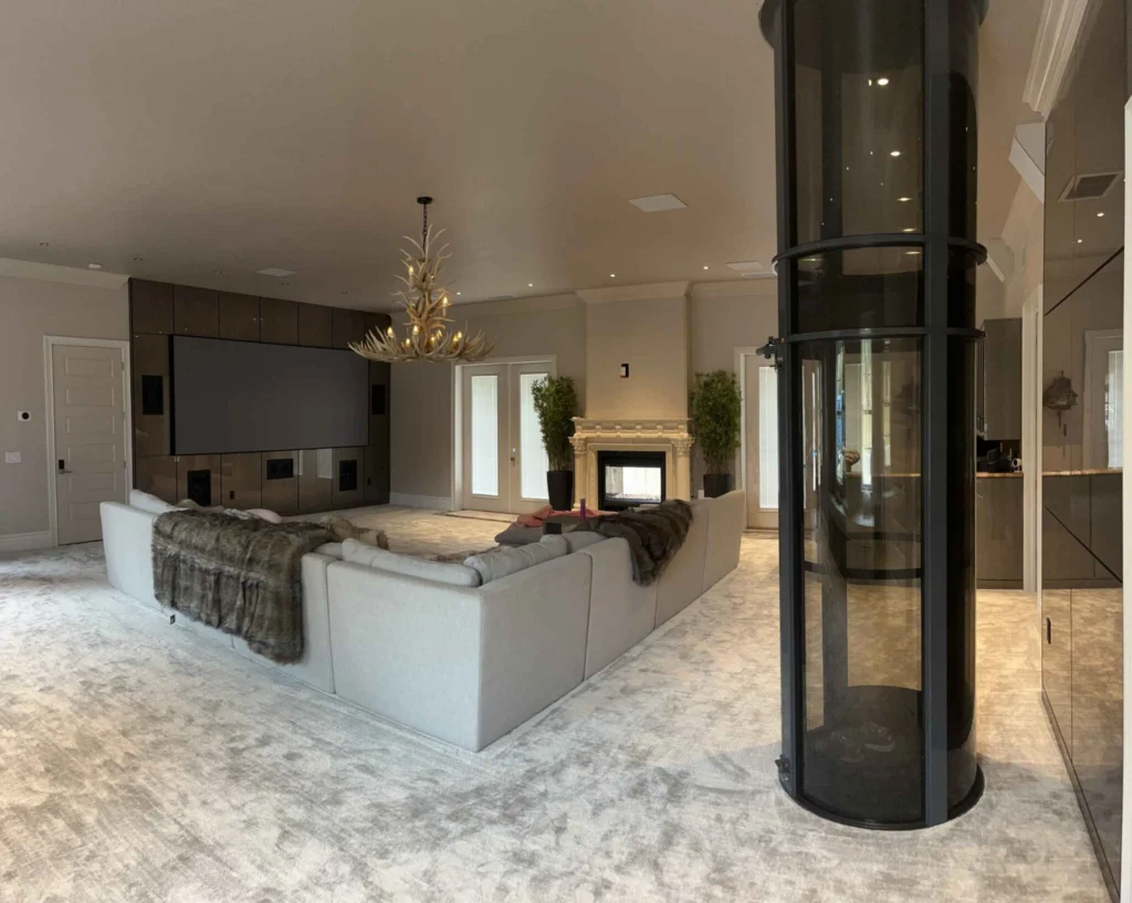 Residential pneumatic vacuum elevator with sleek black design in a modern living room.