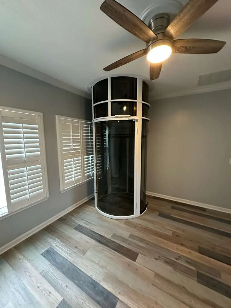 Round home elevator installed in a Florida bedroom