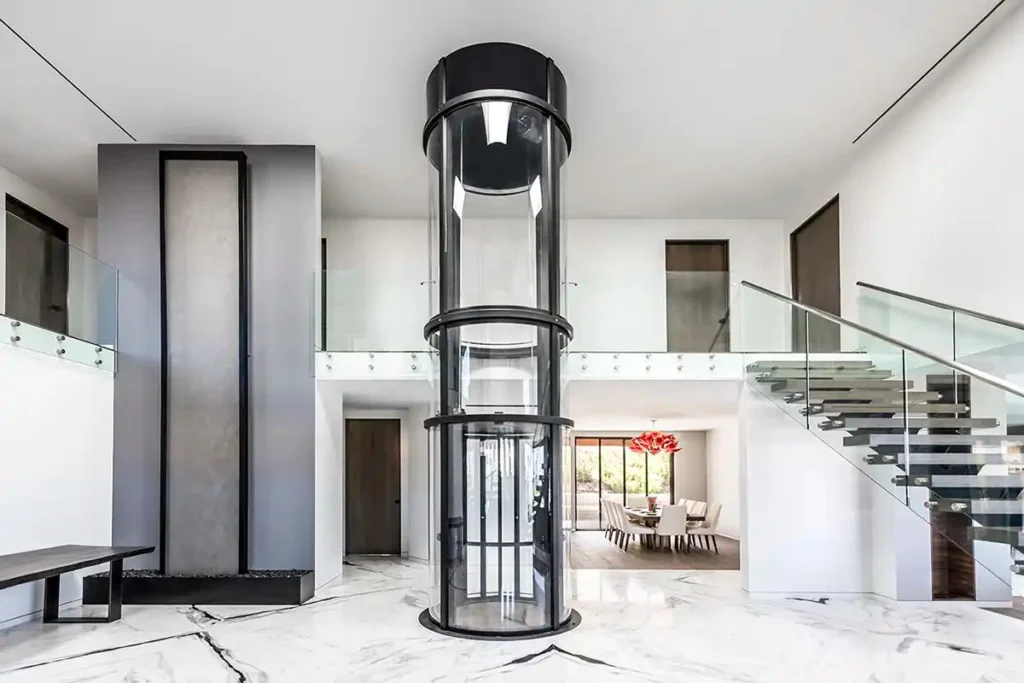 Savaria Vuelift panoramic round home elevator with glass enclosure in a modern luxury Florida residence