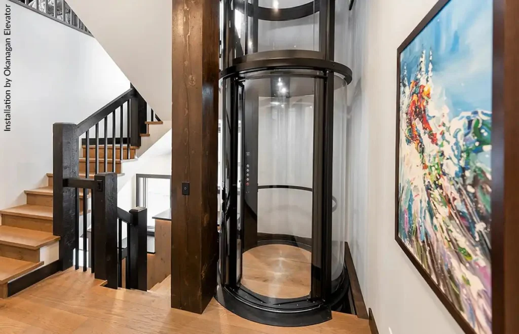 Savaria Vuelift round acrylic residential elevator installed beside a staircase in a modern Florida home
